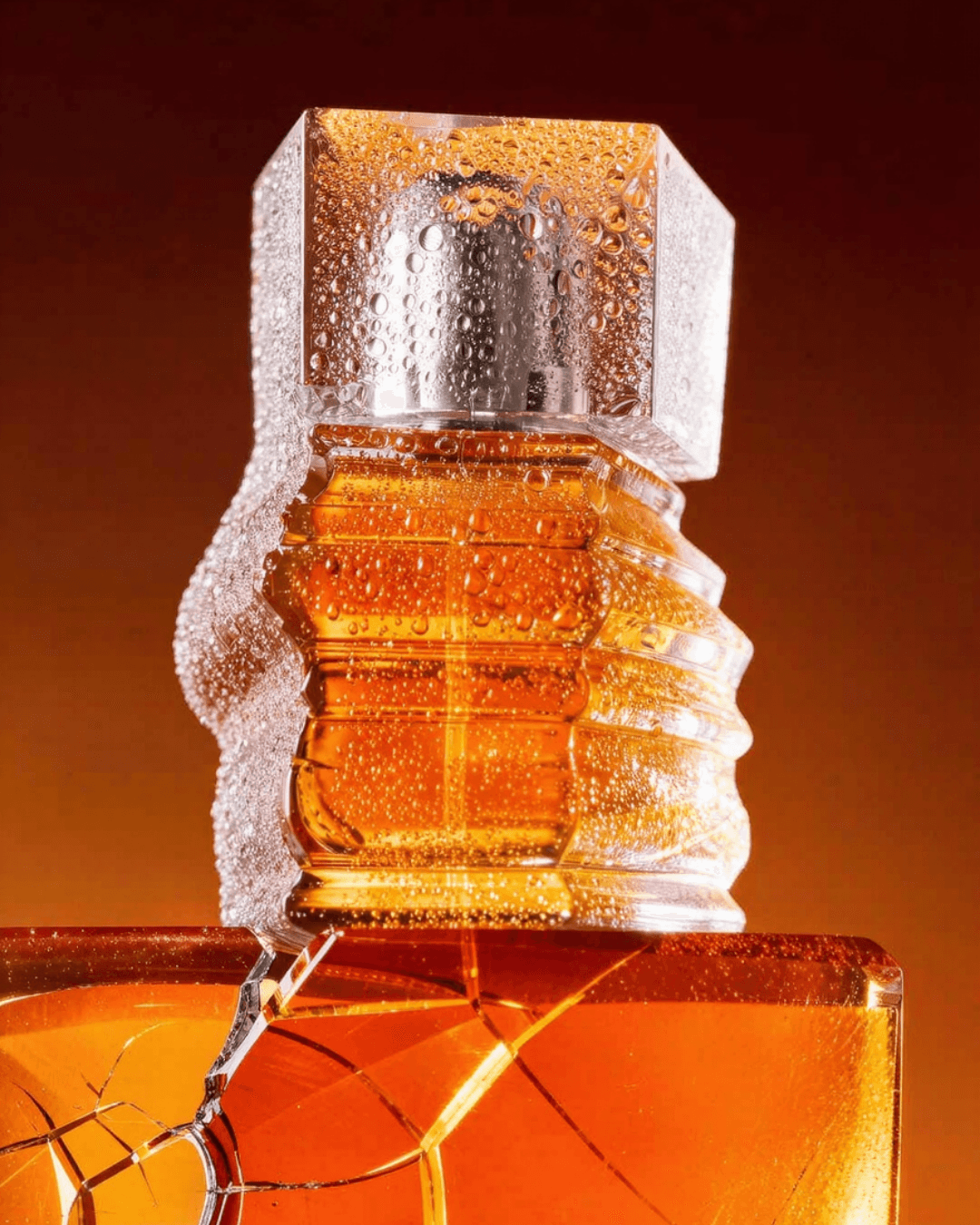 Sculptural amber perfume bottle in warm studio light